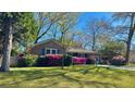 Brick home with well-kept lawn and blooming azaleas enhancing the curb appeal, inviting and picturesque at 2636 Elissa Dr, Charleston, SC 29414