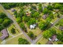 Aerial view showcasing the property's large lot surrounded by mature trees and neighborhood streets at 285 Roosevelt Dr, Saint Stephen, SC 29479