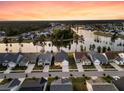 Wide aerial view of a lakeside community featuring tidy homes, manicured lawns, and tranquil waters at 327 Tupelo Lake Dr, Summerville, SC 29486
