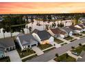 Expansive aerial perspective of a residential area by a lake, with evenly spaced homes and mature trees at 327 Tupelo Lake Dr, Summerville, SC 29486