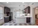 Bright kitchen with white countertops, tile floors, stainless appliances, and dark cabinetry at 35 Society # H, Charleston, SC 29401