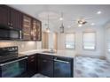 Bright kitchen with white countertops, tile floors, stainless appliances, and dark cabinetry at 35 Society # H, Charleston, SC 29401