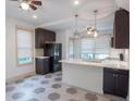 Bright kitchen with white countertops, tile floors, stainless appliances, and dark cabinetry at 35 Society # H, Charleston, SC 29401