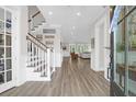 Spacious foyer with hardwood floors, staircase, and a view into the living area at 3587 Goodwater St, Mount Pleasant, SC 29466