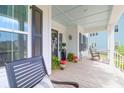 Inviting front porch with rocking chairs, decorative plants, and a ceiling painted haint blue at 3587 Goodwater St, Mount Pleasant, SC 29466
