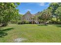 Beautifully landscaped yard surrounds this home with an expansive lawn and mature trees at 3756 Colonel Vanderhorst Circle, Mount Pleasant, SC 29466
