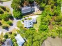 Aerial view showcasing a well-maintained home with a gray roof, nestled among lush trees and greenery in a quiet neighborhood at 380 Tidal Reef Cir, Mount Pleasant, SC 29464