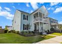 Stylish two-story home with a double porch and well-maintained lawn, creating a welcoming curb appeal at 403 Cool Bend Ln, Summerville, SC 29486