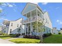 Attractive two-story home with a double porch, complemented by a manicured lawn and lovely landscaping at 403 Cool Bend Ln, Summerville, SC 29486