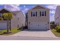 Inviting two-story home with a driveway and manicured lawn in a residential neighborhood at 4916 Paddy Field Way, Ladson, SC 29456