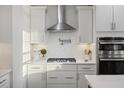 Modern kitchen featuring white cabinets, stainless steel appliances, pot filler, and ample counter space at 555 Dunswell Dr, Summerville, SC 29486