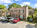 Two-story brick home showcasing manicured lawns and ample parking spaces at 870 Colony Dr # 14, Charleston, SC 29407