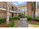 Brick building courtyard with walkway, stairs and ornate ironwork at 870 Colony Dr # 14, Charleston, SC 29407