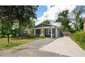 A charming home with a quaint front porch, stone driveway, and lush green surroundings at 928 Sycamore Ave, Charleston, SC 29407