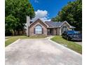 A beautiful brick home featuring a spacious driveway and tasteful landscaping for curb appeal at 9630 N Cardinal Dr, Ladson, SC 29456