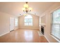 Bright living room with hardwood floors, a fireplace, and large windows for natural light at 9630 N Cardinal Dr, Ladson, SC 29456