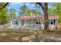 Charming exterior view of home showcasing a white picket fence and a cozy front porch at 9666 Jamison Rd, Ladson, SC 29456