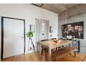 Dining area featuring hardwood floors, modern decor, and a rustic wood table with bench seating at 1 Cool Blow St # 344, Charleston, SC 29403