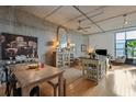 Bright living room with wood floors, concrete ceiling, open floor plan, island, and a dining area at 1 Cool Blow St # 344, Charleston, SC 29403
