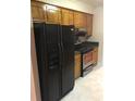 Practical kitchen with stainless steel oven, black refrigerator and wooden cabinets at 1010 Foxcroft Rd, Charleston, SC 29412