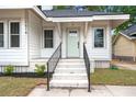 Inviting front porch with gray-painted steps and black metal handrails leading to a stylish, pastel-painted front door at 1014 Alamo St, North Charleston, SC 29405