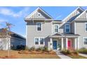 Well-maintained two-story home featuring gray siding and landscaping with colorful doors at 105 Archdale St, Summerville, SC 29486
