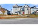 Charming two-story home with a well-maintained lawn and colorful front doors in a neighborhood at 105 Archdale St, Summerville, SC 29486