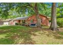 Quaint brick home with a cozy front yard swing, perfect for enjoying the outdoors at 109 Williams Ct, Goose Creek, SC 29445