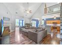 Open living room with vaulted ceilings, a cozy fireplace, and hardwood flooring at 113 Ashton Cv, Summerville, SC 29485