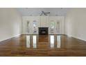 Sun-filled living room with hardwood floors, fireplace, ceiling fan and access to outdoor balconies at 1150 Quick Rabbit Loop, Charleston, SC 29414