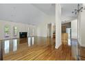 Spacious living room with vaulted ceiling, fireplace, gleaming hardwood floors, and open floor plan at 1150 Quick Rabbit Loop, Charleston, SC 29414