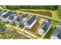 Aerial view of a community with well-manicured lawns and a serene pond at 117 Osprey Ridge Ln, Summerville, SC 29483