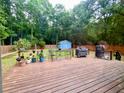 Spacious wooden deck with outdoor seating and a grill, perfect for entertaining and relaxing in the backyard at 1325 Edward Dr, Moncks Corner, SC 29461