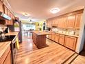Bright kitchen with wooden cabinets, butcher block countertops, and an island, seamlessly connecting to the dining area at 1325 Edward Dr, Moncks Corner, SC 29461