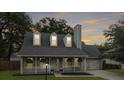 Beautiful home featuring a welcoming front porch and a two car garage, set against a twilight sky at 1410 Diamond Boulevard, Mount Pleasant, SC 29466