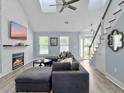 Cozy living room with a fireplace, modern lighting, vaulted ceiling, and comfortable seating area at 1410 Diamond Boulevard, Mount Pleasant, SC 29466