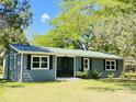 Exterior front view of home featuring new paint, new roof, and manicured lawn at 1425 Risher Mountain Rd, Walterboro, SC 29488