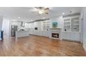 Spacious living area featuring hardwood floors, fireplace, and built-in shelving for a cozy and stylish space at 148 Cowrie Ct, Mount Pleasant, SC 29464