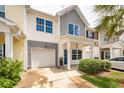 Townhome featuring attached garage, covered entrance, and well-manicured landscaping at 151 Kirkland St, Goose Creek, SC 29445