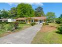 Inviting single story home with a mature shade tree, manicured lawn and concrete driveway at 1575 Langston Dr, Johns Island, SC 29455