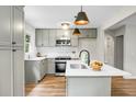 Modern kitchen with gray cabinets, stainless steel appliances, and a stylish island with a sink at 1621 Point Park Dr, Johns Island, SC 29455