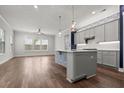 Open kitchen features a center island with bar seating, stylish pendant lighting, and a subway tile backsplash at 1661 Indy Dr, North Charleston, SC 29405