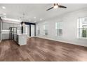 Bright, airy living room seamlessly flows into a modern kitchen with a stylish island and stainless steel appliances at 1661 Indy Dr, North Charleston, SC 29405