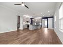 Spacious living room features an open floor plan to the kitchen with gorgeous hardwood floors and abundant natural light at 1661 Indy Dr, North Charleston, SC 29405