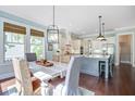 Bright dining area next to the kitchen features a modern light fixture and large windows at 1776 W Canning Dr, Mount Pleasant, SC 29466