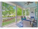 Relaxing screened-in porch with comfortable seating and a view of the landscaped backyard at 1776 W Canning Dr, Mount Pleasant, SC 29466