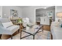 Elegant living area with a glass coffee table and stylish seating at 1790 Brockington Ave, Charleston, SC 29407