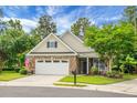 Beautiful brick home with two-car garage, and well-manicured lawn; American flag, too at 184 Angora Way, Summerville, SC 29485