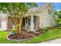 Inviting home with a brick facade, rocking chairs on the front porch, and a beautifully landscaped garden at 184 Angora Way, Summerville, SC 29485