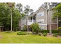 A well-maintained multi-story apartment building featuring lush landscaping and inviting walkways offers a beautiful exterior at 188 Midland Parkway # 110, Summerville, SC 29485
